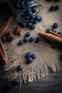 Blueberries and cinnamon sticks on jute cloth Blueberries and cinnamon sticks on jute cloth